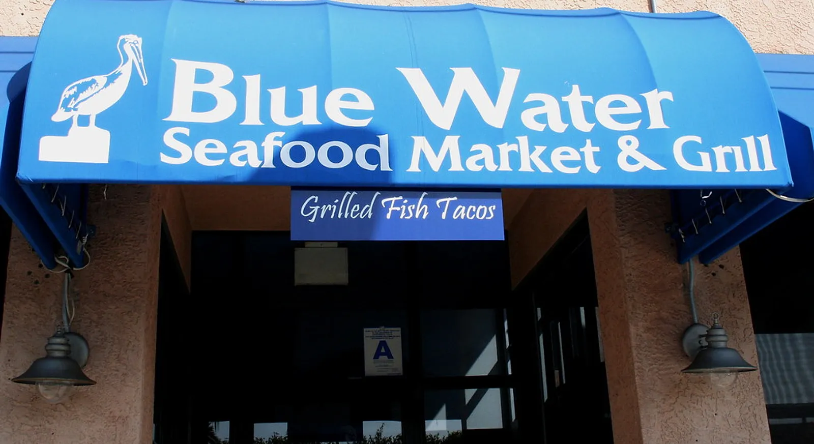 The sign of Blue Water Seafood Market & Grill, known for grilled fish tacos, in San Diego