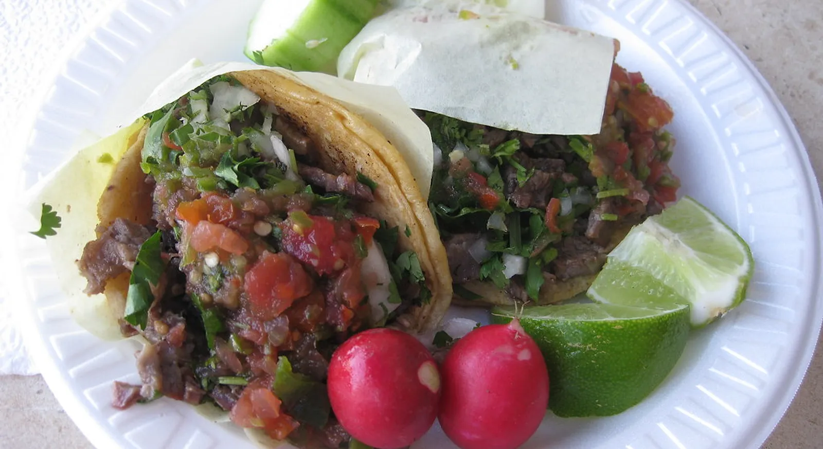 Carne asada tacos with salsa, radish and lime at a market in Chula Vista, California