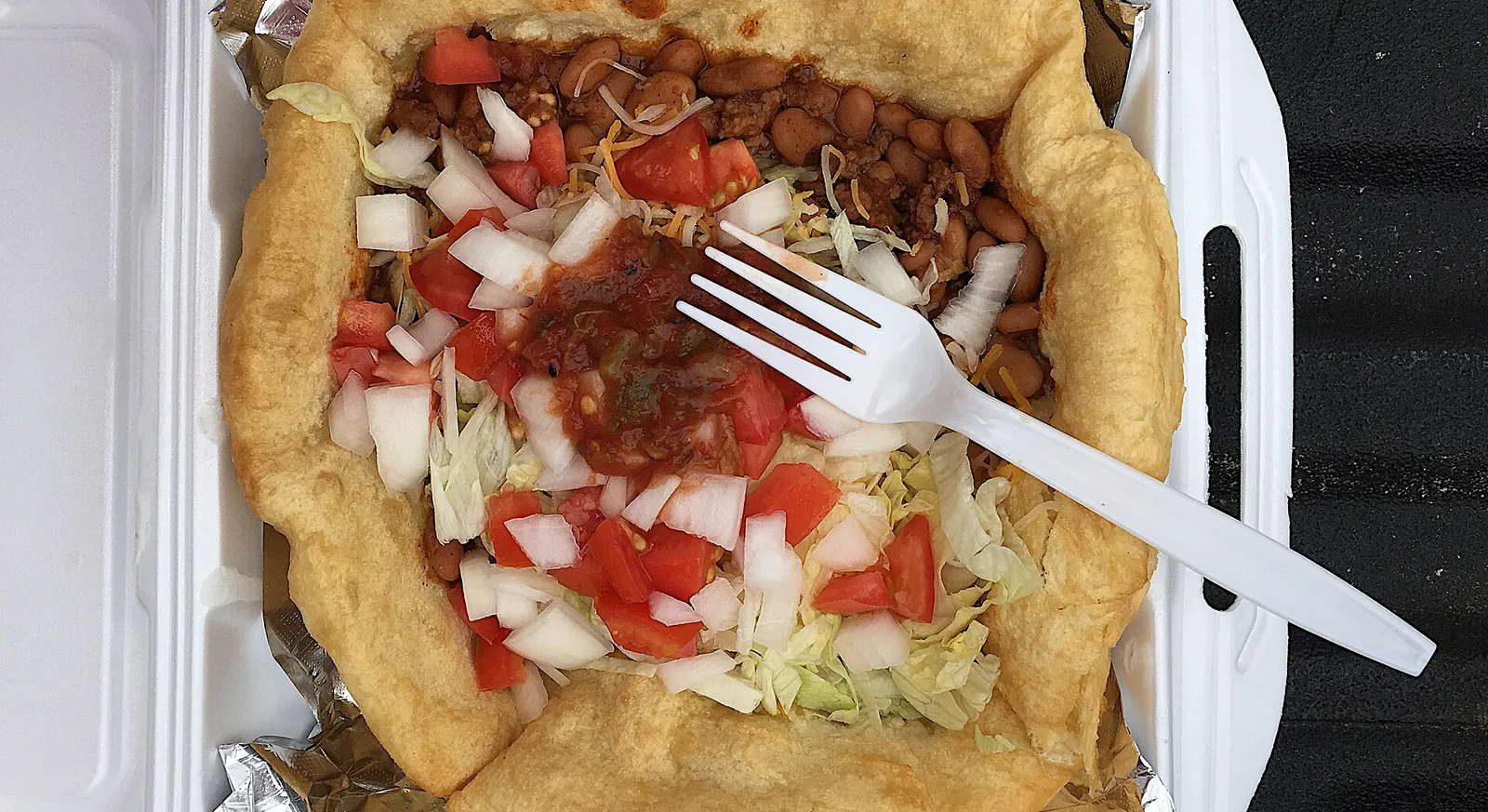 A classic Navajo taco on fry bread with beans, lettuce, tomato and cheese in Cortez, Colorado