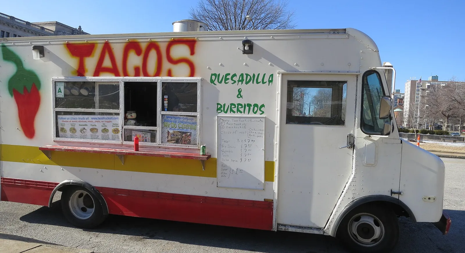 A white taco truck selling tacos, quesadillas and burritos, parked in St. Louis, Missouri