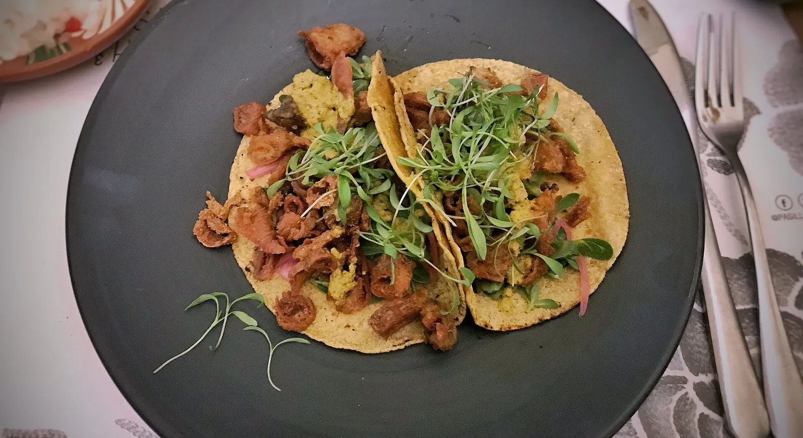 Tacos de tripa with crispy beef tripe, grilled onions, avocado and cilantro