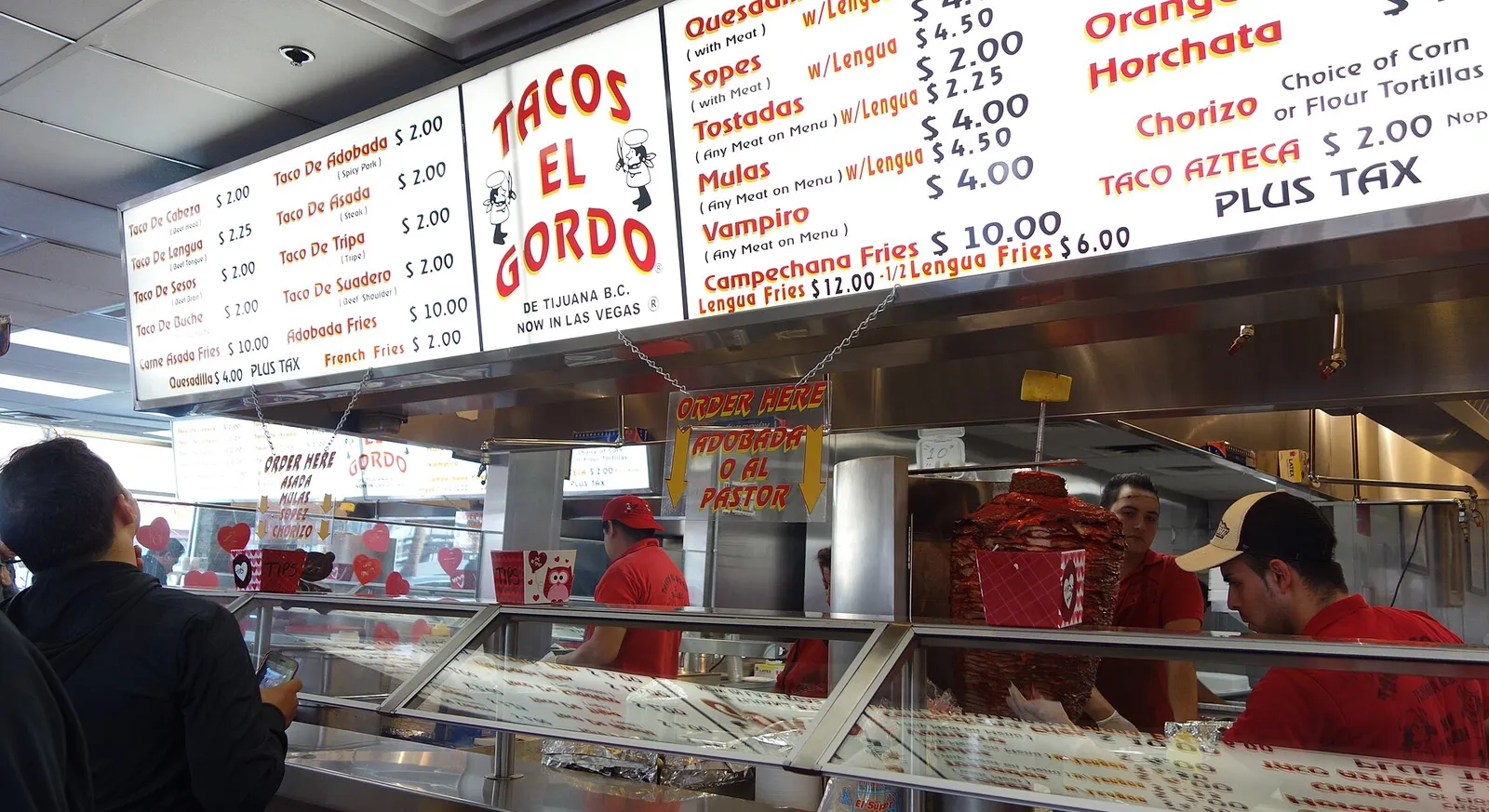 The taco counter and menu board at Tacos El Gordo in Las Vegas