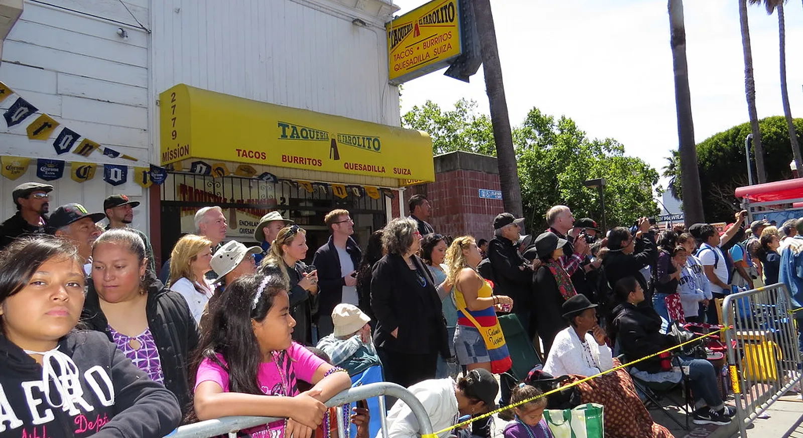 A crowd on 24th Street outside Taqueria El Farolito in San Francisco's Mission District