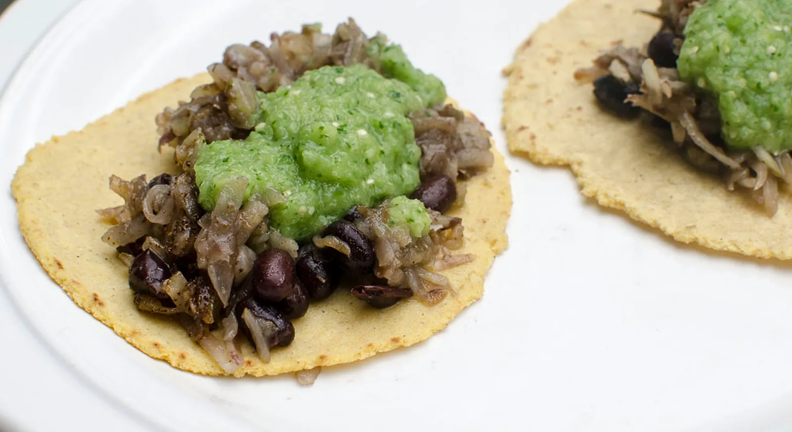 Vegan tacos with crispy hash browns and salsa verde on corn tortillas