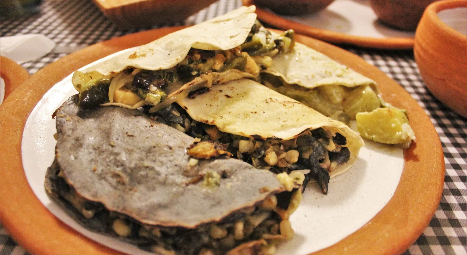 Vegetarian tacos with refried beans and sauteed greens at Cabuche